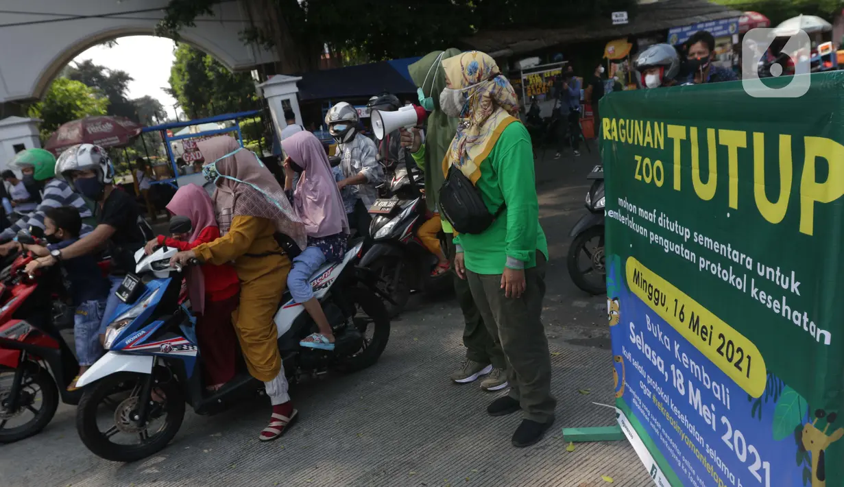 Petugas Satpol PP memberitahu warga terkait penutupan kawasan Kebun Binatang Ragunan, Jakarta, Minggu (16/5/2021). Sejumlah kawasan wisata di DKI Jakarta ditutup sementara untuk umum hingga 18 Mei 2021 untuk pemberlakukan penguatan protokol kesehatan COVID-19. (Liputan6.com/Helmi Fithriansyah)