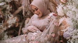 Syifa tersenyum sambil memegang perutnya yang tampak sudah sangat besar. [Foto: Instagram/ syifaasyifaaa]