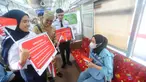 Petugas KRL Commuterline membawa poster saat peringatan Hari Sumpah Pemuda di Stasiun Bogor, Jawa Barat, Senin (28/10/2024). (merdeka.com/Arie Basuki)
