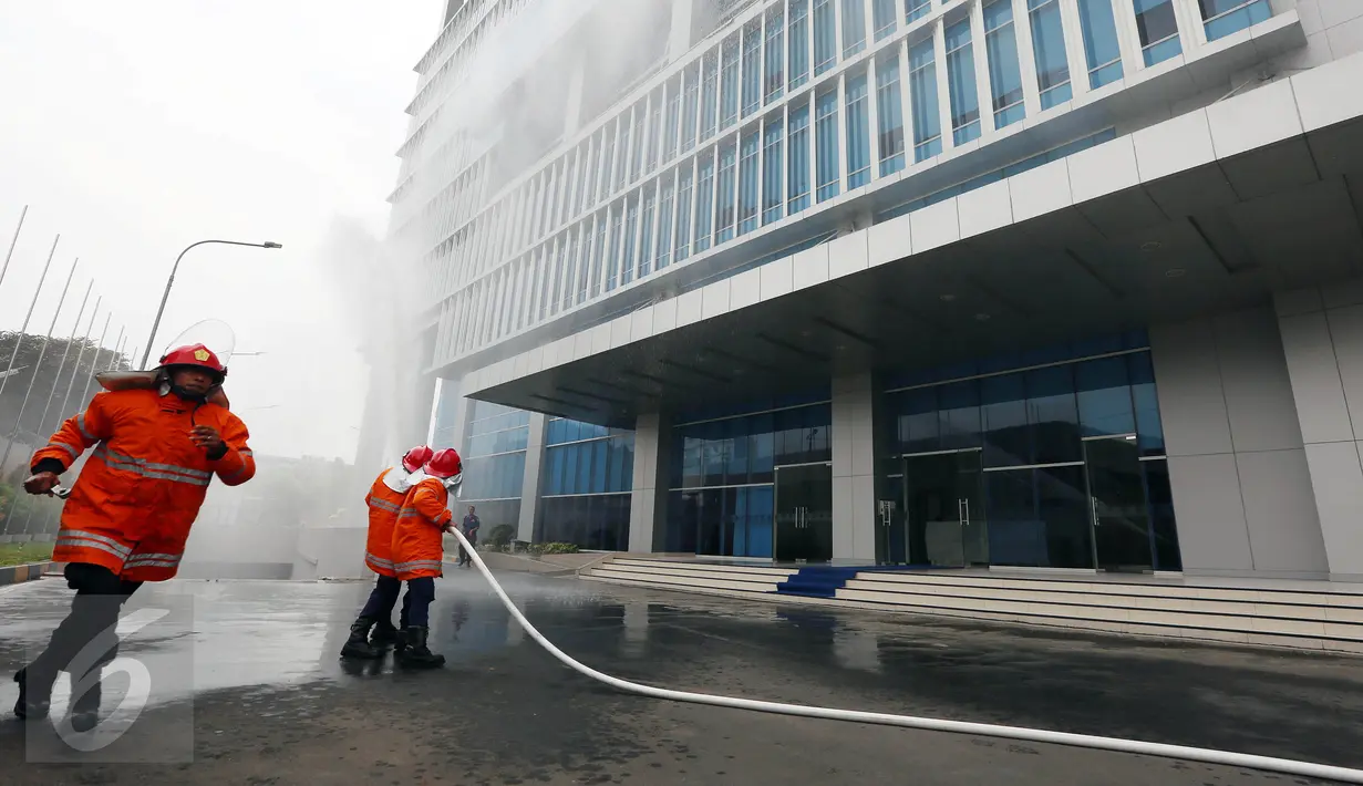 Petugas BNPB menyiramkan air saat melakukan simulasi Gempa Bumi dan Kebakaran di Kantor BNPB, Jakarta, Rabu (26/4). Simulasi ini juga bertujuan menumbuhkan budaya sadar bencana dan guna mengurangi resiko saat terjadi musibah. (Liputan6.com/Johan Tallo)