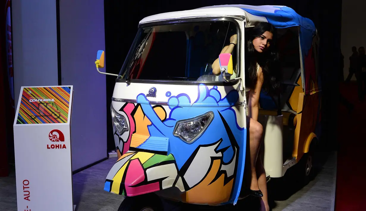 Model berpose di samping motor Honda Africa Win saat Indian Auto Expo 2018 di Greater Noida, New Delhi, India, (7/2). (AFP Photo/Sajjad Hussain)