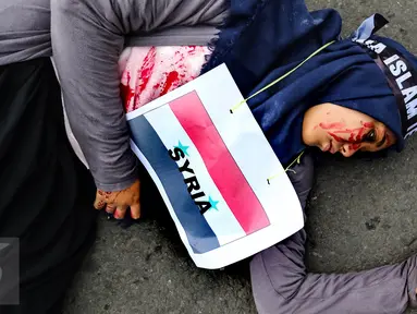 Seorang demonstran dengan bendera Syria yang dikalungkan di leher melakukan aksi keprihatinan saat Car Free Day (CFD) di Bundaran HI, Jakarta (14/08). (Liputan6.com/Fery Pradolo).