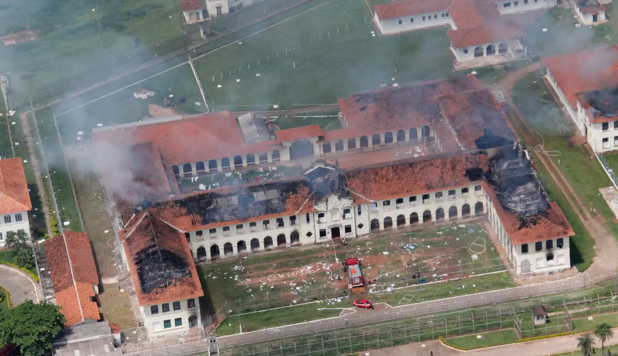Para napi membakar salah satu ruang tahanan Pusat Progresi Lembaga Pemasyarakatan di kota Bauru, barat laut Sao Paulo, Brasil, Selasa (24/1). 62 narapidana kabur setelah kerusuhan yang memicu kebakaran. (ACEITUNO JUNIOR/JORNAL DA CIDADE/AFP)