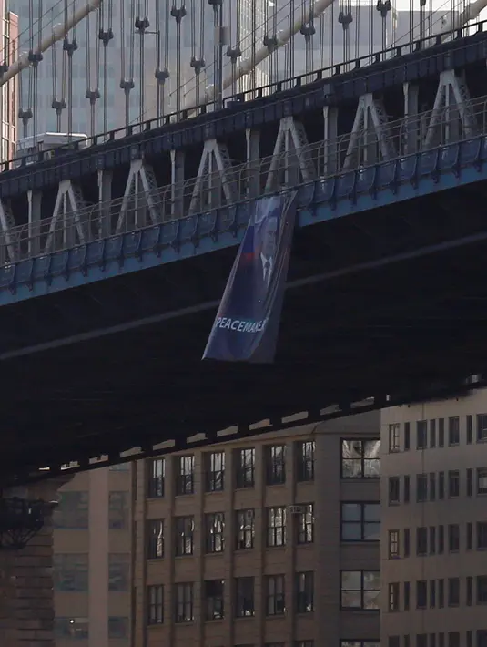 Pemandangan banner raksasa bergambar Presiden Rusia Vladimir Putin di Jembatan Manhattan, New York, Kamis (6/10). Banner Putin itu tergantung di sisi atas Manhattan Bridge yang terletak antara Manhattan dan borough Brooklyn. (REUTERS/Brendan McDermid)