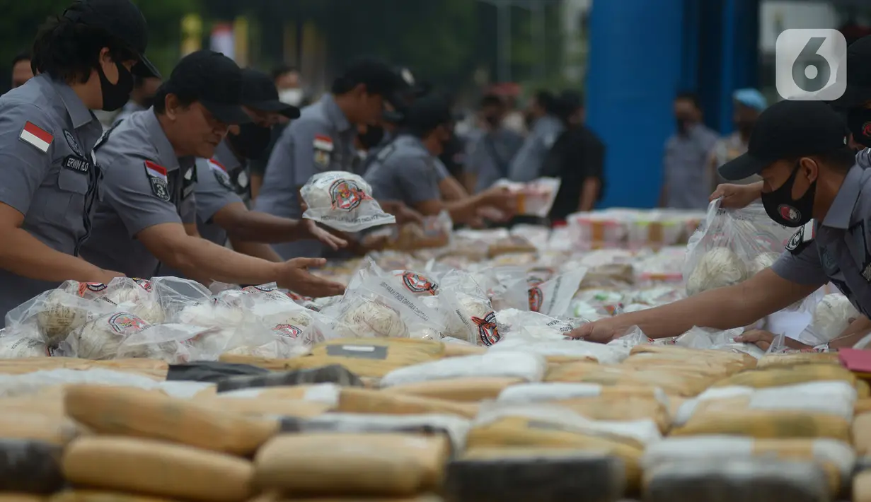 Petugas merapikan barang bukti narkoba jenis sabu di Lapangan Polda Metro Jaya, Jakarta, Kamis (2/7/2020). Narkoba tersebut merupakan hasil sitaan dari jaringan internasional Iran dan Timur Tengah yang berhasil diamankan oleh tim di Serang, Banten dan Sukabumi, Jawa Barat. (merdeka.com/Imam Buhori)