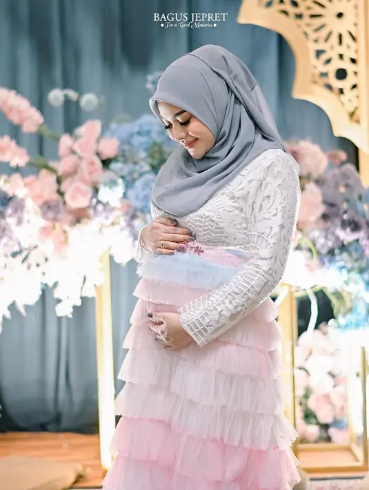 Ingat momen gender reveal untuk anak kedua Aurel Hermansyah? Di sini, ia tampil memikat dengan outfit berwarna pastel, hijab abu-abu yang lembut, dipadu atasan brokat putih, dan rok tutu bertingkat dari warna pink dan biru pastel. [Foto: Instagram/aurelie.hermansyah]