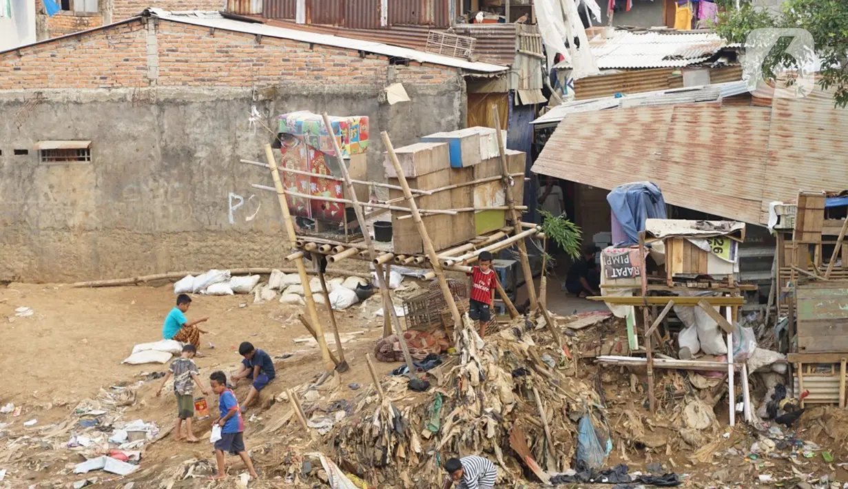 Anak-anak bermain di sekitar pemukiman bantaran Sungai Ciliwung, Jakarta, Jumat (17/7/2020). Badan Pusat Statistik menyebut tingkat kemiskinan di RI kini membengkak jadi 9,78 persen dari total populasi nasional akibat pandemi virus corona COVID-19. (Liputan6.com/Immanuel Antoniu)