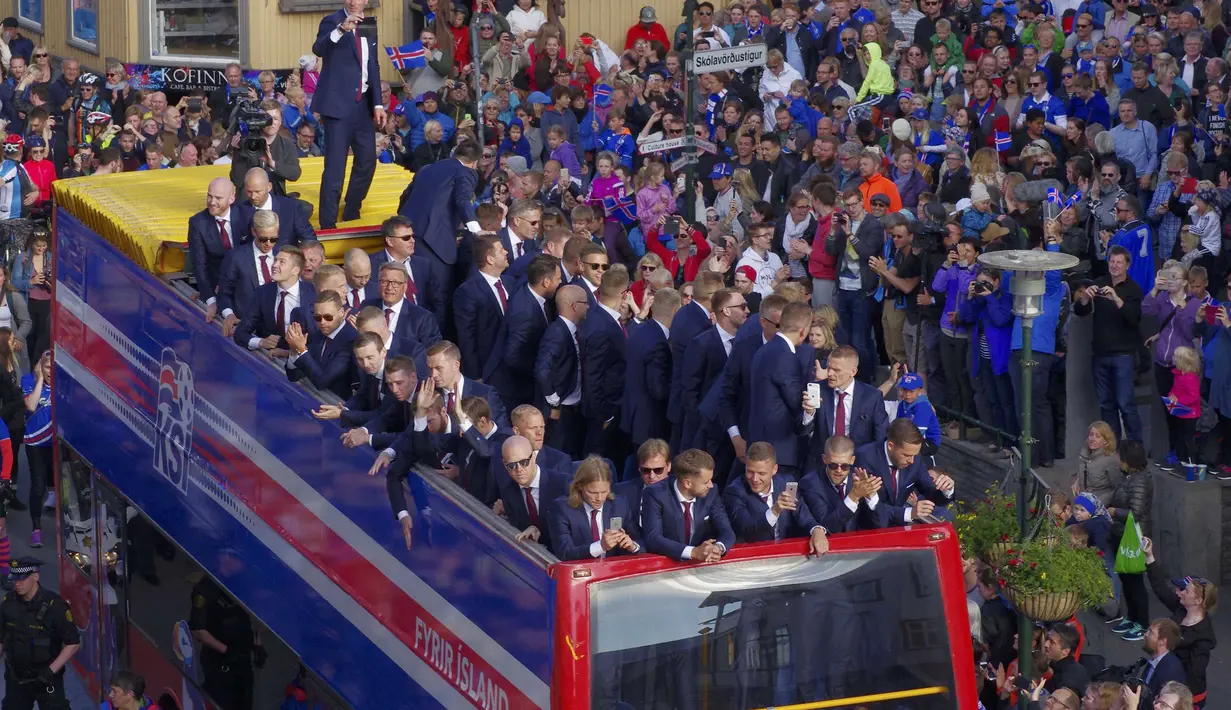 Para pemain Islandia ikut memotret dan memberikan salam kepada warga yang  menyambut kedatangan tim usai berlaga pada Piala Eropa 2016 di Reykjavik, Islandia, (4/7/2016). (REUTERS/Geirix)