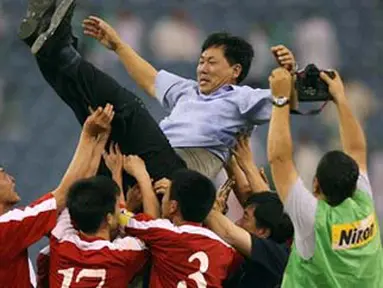 Pelatih Korea Utara, Kim Jong Hun bersama para pemainnya merayakan keberhasilan lolos ke Piala Dunia 2010 Afrika Selatan, setelah bermain 0-0 dengan Saudi Arabia pada 17 Juni 2009 di Riyadh. AFP PHOTO/MIDO AHMED
