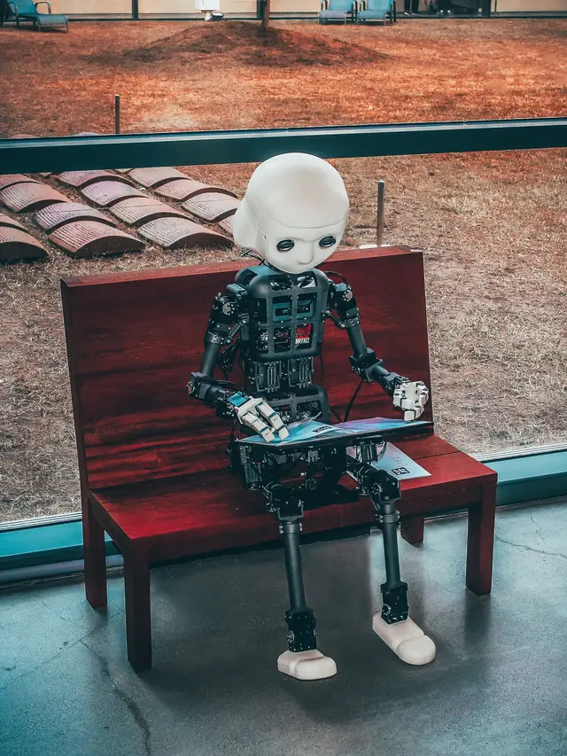 Ilustrasi robot berbahasa isyarat. Photo by Andrea De Santis on Unsplash