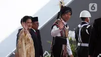 Presiden Joko Widodo atau Jokowi (kanan) bersama Ibu Negara Iriana melambaikan tangan saat tiba di lokasi Sidang Tahunan MPR dan Sidang Bersama DPR-DPD Tahun 2023 di Gedung Nusantara, Kompleks Parlemen, Senayan, Jakarta, Rabu (16/8/2023). Jokowi mengenakan baju adat Tanimbar, Maluku. (Liputan6.com/Johan Tallo)