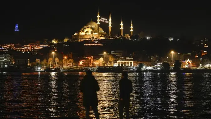Pesan lampu yang dipasang di antara menara masjid Suleymaniye bertuliskan dalam bahasa Turki “Ramadhan adalah bulan Al-Quran” menjelang bulan suci Ramadhan di Istanbul, Turki, Minggu, 10 Maret 2024. (AP Photo/Emrah Gurel)