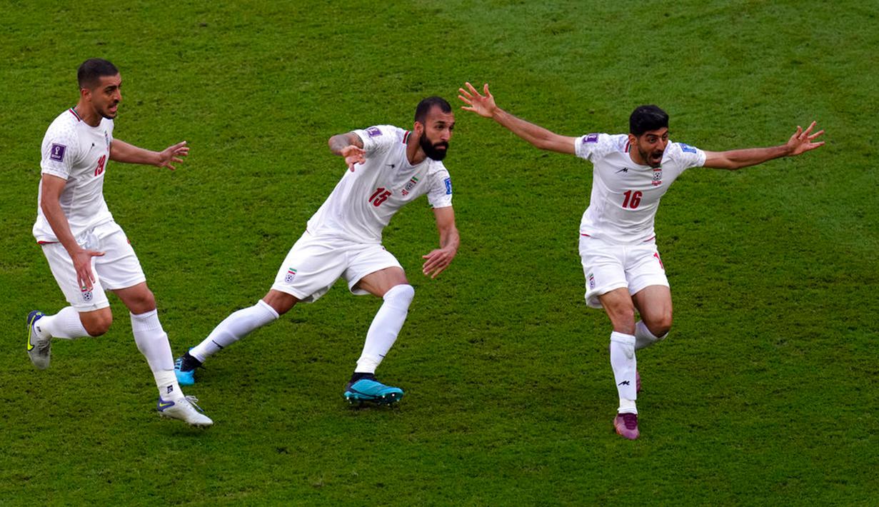 Pemain Iran Rouzbeh Cheshmi (tengah) merayakan dengan rekan setimnya setelah mencetak gol ke gawang Wales pada pertandingan sepak bola Grup B Piala Dunia 2022 di Stadion Ahmad Bin Ali, Al Rayyan, Qatar, Jumat (25/11/2022). Iran mengalahkan Wales dengan skor 2-0. (AP Photo/Manu Fernandez)