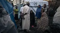 Berjalan melewati gubuk-gubuk kecil yang dibangun dengan tergesa-gesa di atas tanah vulkanik, ia menjelaskan bahwa salah satu masalah terbesar adalah kurangnya air bersih. (ALEXIS HUGUET / AFP)