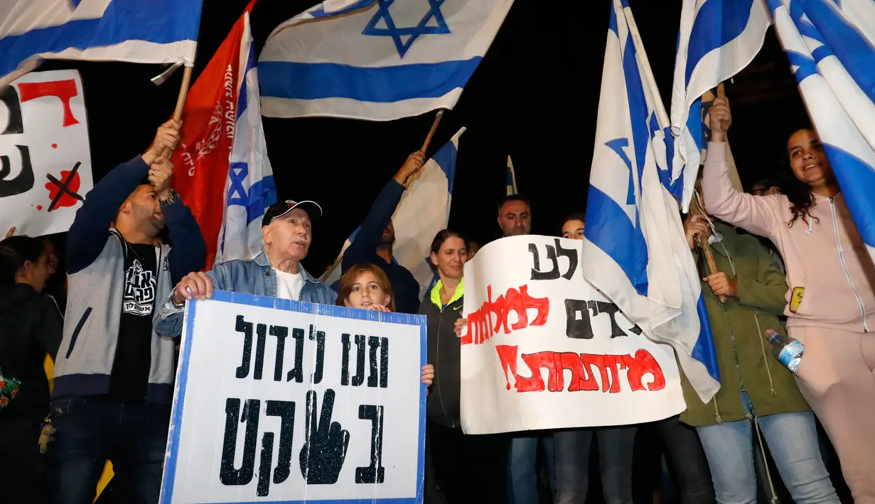 Warga berdemonstrasi menentang gencatan senjata dengan Hamas di Kota Ashkelon Selatan, Israel, Rabu (14/11). Peningkatan kekerasan di Gaza menjadi yang terburuk sejak perang 2014. (JACK GUEZ/AFP)