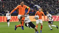 Bek Belanda, Virgil Van Dijk, berebut bola dengan penyerang Jerman, Thomas Mueller, pada laga UEFA Nations League di Veltins Arena, Gelsenkirchen, Senin (19/11/2018). Kedua tim bermain imbang 2-2. (AP/Martin Meissner)