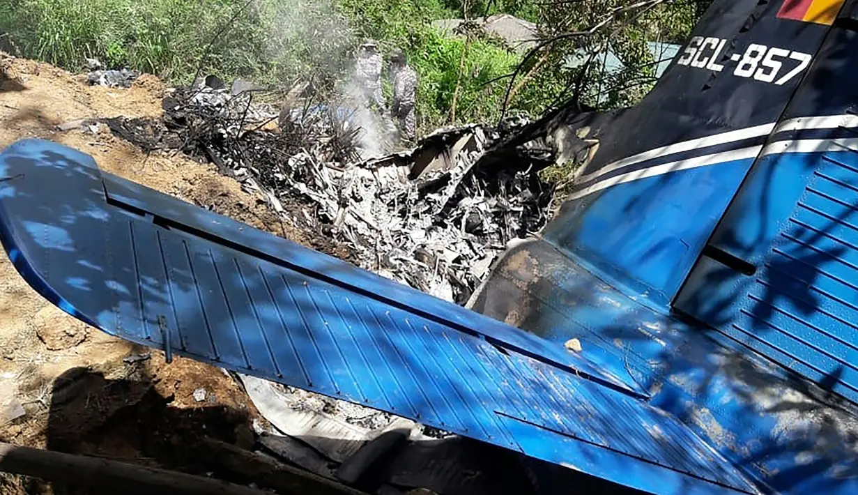 Petugas penyelamat memeriksa puing-puing  pesawat milik Angkatan Udara Sri Lanka yang jatuh di daerah pegunungan penghasil teh di Haputale, Jumat (3/1/2020). Hingga kini masih dilakukan investigasi terkait penyebab kecelakaan. (Photo by STR / AFP)