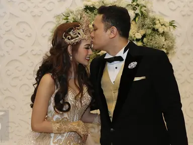 Presenter Gilang Dirga mencium kening istrinya, Adiezty Fersa seusai jumpa pers pernikahan mereka di Kelapa Gading, Jakarta, Minggu (18/9). Gilang Dirga mempersunting Adiezty dengan mas kawin uang tunai sebesar Rp 300.314. (Liputan6.com/Herman Zakharia)