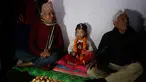 Gadis berusia lima tahun yang bernama Nihira Bajracharya (tengah) diapit oleh pendeta Hindu setelah dia ditunjuk sebagai Dewi Hidup baru yang dikenal Kumari di sebuah kuil Hindu di Patan, Lalitpur, Nepal (5/2). (AP Photo / Niranjan Shrestha)