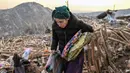 Warga mengambil dan mengumpulkan barang-barang pribadi yang masih bisa digunakan dari reruntuhan rumah mereka di desa Yaylakonak distrik Adiyaman, Turki, Minggu (19/2/2023). 108 jiwa meninggal dan 170 rumah ambruk di Desa Yaylakonak distrik Adiyaman, Turki akibat gempa berkekuatan 7,8 magnitudo yang terjadi pada 6 Februari lalu. (BULENT KILIC/AFP)