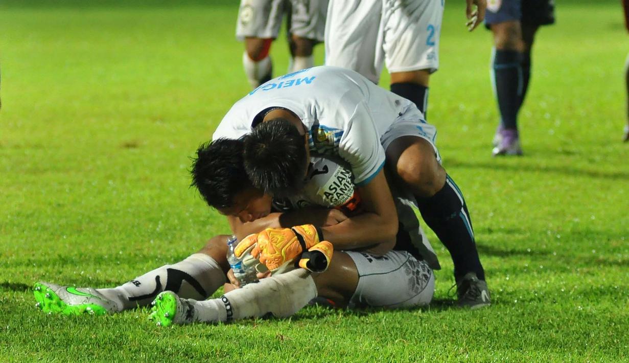Kiper Arema Cronus, Kurnia Meiga, menghibur bek Sriwijaya FC, Ahmad Jufriyanto sesaat setelah semifinal Torabika Bhayangkara Cup 2016 di Stadion Kanjuruhan, Kabupaten Malang, Kamis (31/3/2016). (Bola.com/Iwan Setiawan)