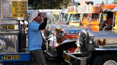Seorang pengemudi jeepney beristirahat sambil minum air di terminal kota Pasay, Filipina, pada Senin, 23 Maret 2026. (AP Photo/Aaron Favila)