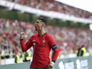 Penyerang Portugal Cristiano Ronaldo merayakan gol yang dicetaknya ke gawang Irlandia pada laga uji coba internasional terakhir jelang putaran final Euro 2024 di Stadion Municipal de Aveiro, Rabu (12/6/2024) dini hari WIB. (AP Photo/Luis Vieira)
