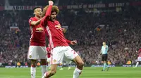 Gelandang Manchester United, Marouane Fellaini melakukan selebrasi usai mencetak gol ke gawang Celta Vigo pada leg kedua Liga Europa di stadion Old Trafford, Inggris,(11/5). MU melaju ke final usai menang dengan aggregat 2-1. (AFP Photo/Miguel Riopa)