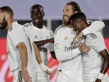 Para pemain Real Madrid merayakan gol yang dicetak oleh Vinicius Junior ke gawang Real Mallorca pada laga La Liga di Stadion Alfredo Di Stefano, Kamis (25/6/2020). Real Madrid menang 2-0 atas Real Mallorca. (AP/Bernat Armangue)