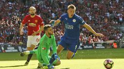 Pemain Leicester City, Jamie Vardy berebut bola dengan kiper Manchester United David De Gea pada Community Shield di Stadion Wembley Minggu (7/8/2016). (AP Photo/Frank Augstein)