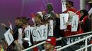 Sekelompok suporter Indonesia saat mendukung Timnas Indonesia menghadapi Vietnam pada laga kedua Grup D Piala Asia 2023 di Abdullah Bin Khalifa Stadium, Doha, Qatar, Jumat (19/1/2024). (AFP/Karim Jaafar)