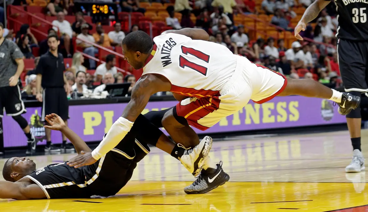 Guard Miami Heat, Dion Waiters (11), berebut bola dengan pemain guard Brooklyn Nets, Isaiah Whitehead, dalam laga pramusim NBA 2016-2017 di American Airlines Arena, Miami, Florida, AS, Selasa (11/10/2016). (AP Photo/Alan Diaz)