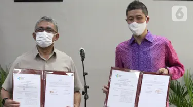 Sekretaris Jenderal Kemenkes Oscar Primadi dan CEO & Cofounder Halodoc Jonathan Sudharta menunjukkan penandatanganan nota kesepahaman (MoU) di Gedung Kemenkes, Jakarta Senin (1/3/2021). Kerjasama dalam rangka percepatan program vaksinasi Covid-19. (Liputan6.com/Fery Pradolo)