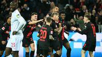 Pemain Bayer Leverkusen merayakan gol yang dicetak Robert Andrich dalam laga kontra Mainz 05 di BayArena, Sabtu (24/2/2024) dini hari WIB. (INA FASSBENDER / AFP)