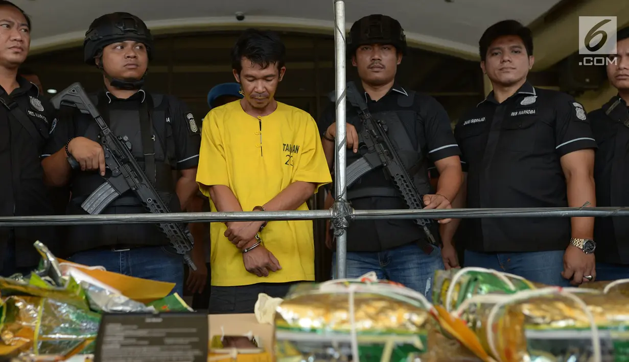 Seorang tersangka dihadirkan dalam rilis penyelundupan kasus narkotika jenis sabu ke kos-kosan di Mapolres Metro Jakarta Utara, Selasa (6/8/2019). Aparat kepolisian mengamankan seorang pengedar berinisial DA pada 27 Juli lalu saat menyelundupkan 10 kg sabu-sabu ke indekos. (merdeka.com/Imam Buhori)