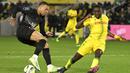Di akhir babak pertama Nantes nyaris kehilangan bek Dennis Appiah. Hukuman kartu merah langsung akibat pelanggaran terhadap Kylian Mbappe ditukar dengan kartu kuning usai wasit meninjau VAR. (AFP/Loic Venance)