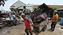 Warga mengumpulkan puing sisa kebakaran di Pasar  Inpres Tanah Abang, Jakarta, Minggu (11/10/2015). Kebakaran yang terjadi pada Minggu (11/10) dini hari tersebut menghanguskan 136 kios (Liputan6.com/Immanuel Antonius)