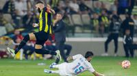 Pemain Al Ittihad, Karim Benzema, berusaha melewati pemain Al Nassr, Alex Telles, dalam laga tunda pekan ke-17 Liga Arab Saudi di King Abdullah Sport City Stadium, Jeddah, Rabu (27/12/2023). Laga ini dihiasi para mantan pemain bintang di Eropa. (Photo by AFP)