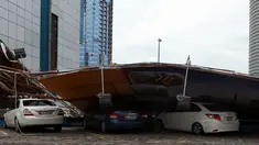 Papan reklame tumbang menimpa sejumlah mobil usai badai hujan, Abu Dhabi (9/3/2016 ). Akibat hujan lebat ini, sekolah diliburkan dan penerbangan ditunda. (AFP Photo)