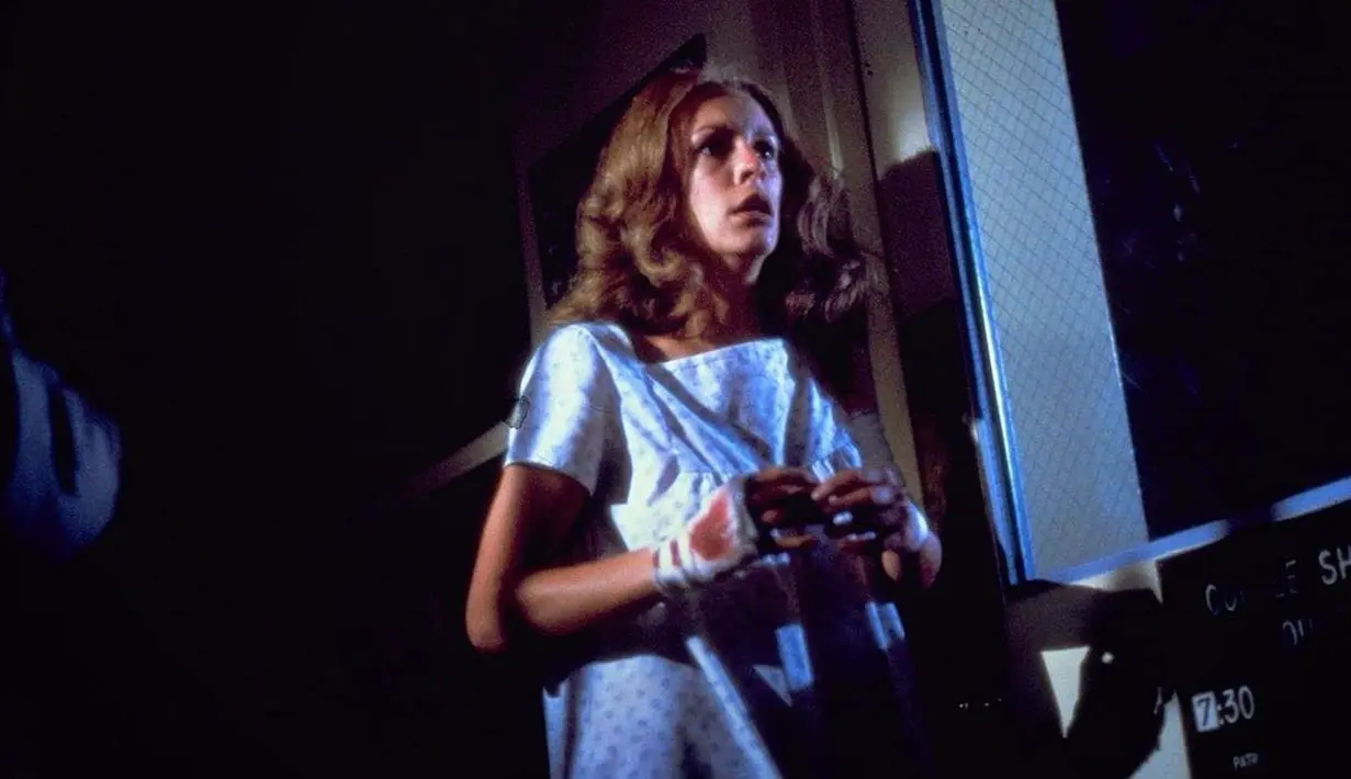 Sukses secara komersial membuat Halloween versi 1978 melahirkan sekuel tiga tahun kemudian. Kisahnya bermula dari Michael Myers ditembak psikiatrisnya, Sam Loomis. Ia jatuh dari balkon. Apes, Michael Myers bertahan hidup dan berhasil kabur. Teror terulang lagi. Daya tahan Laurie Strode sebagai penyintas kembali diuji. Ini salah satu adegan yang menampilkan Jamie Lee Curtis. (Foto: Dok. Universal Pictures/ IMDb)