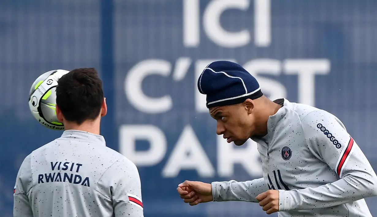 <p>Penyerang Paris Saint-Germain (PSG) Kylian Mbappe (kanan) menyundul bola saat sesi latihan di tempat latihan klub Camp des Loges di Saint-Germain-en-Laye, barat Paris, Kamis (28/4/2022). Juara Ligue 1 yang baru dinobatkan PSG akan dijamu oleh Strasbourg pada pekan ke-35 Ligue 1 2021/22, Sabtu 30 April 2022, di Stade de la Meinau. (FRANCK FIFE / AFP)</p>