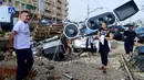 Aliran lumpur menerjang kendaraan di jalan-jalan dengan kecepatan tinggi. (Jose Jordan/AFP)