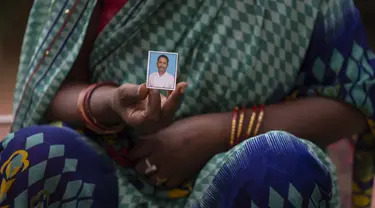 Savita Devi menunjukkan foto suaminya Manoj yang tubuhnya tidak dapat diidentifikasi setelah kecelakaan kereta api hari Jumat di Balasore, di rumah sakit All India Institute of Medical Sciences di Bhubaneswar, di negara bagian timur Odisha, India, Selasa (6/6/2023). (AP Photo/Rafiq Maqbool)