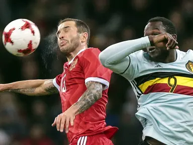 Pemain Belgia, Romelu Lukaku (kanan) berduel dengan pemain Rusia, Fedor Kudryashov pada laga persahabatan di Fisht stadium, Sochi, Rusia, Selasa (28/3/2017). Rusia bermain imbang 3-3. (AP/Denis Tyrin)