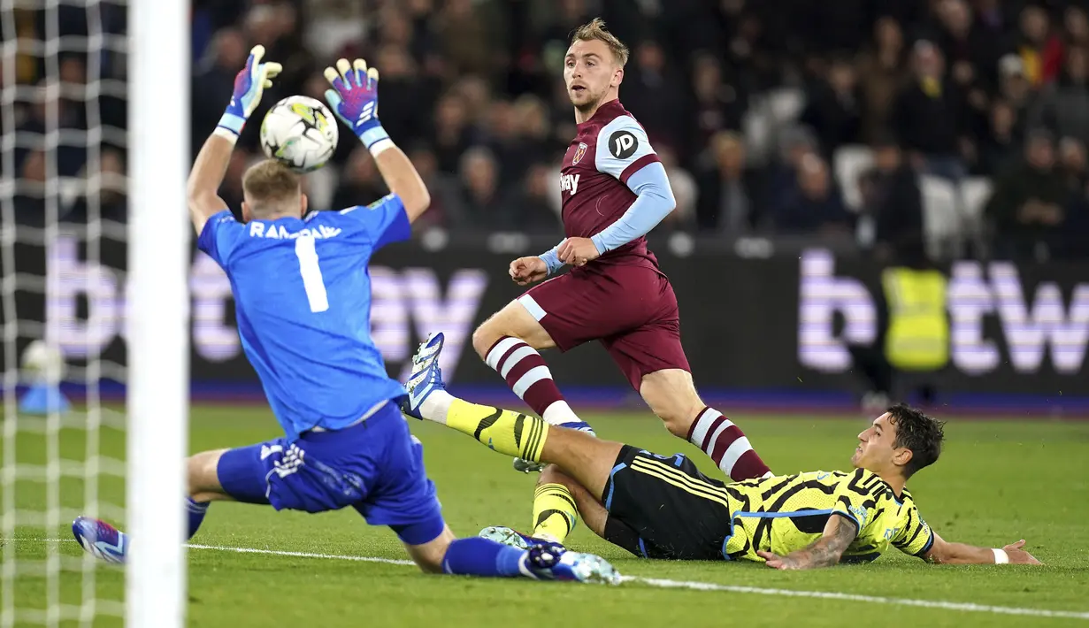 Di ajang Piala Liga Inggris 2023/2024, Arsenal hanya bertahan hingga babak 16 besar setelah kalah 1-3 dari West Ham United dalam laga yang digelar di London Stadium (1/11/2023). Tiga gol kemenangan The Hammers dicetak lewat gol bunuh diri Ben White (16'), Mohammed Kudus (50') dan Jarrod Bowen (60'). Satu-satunya gol The Gunners dicetak lewat Martin Odegaard (90+6). (PA via AP Photo/John Walton)