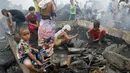 Sejumlah anak berkumpul di lokasi permukiman yang habis terbakar di Navotas, Metro Manila Filipina, Selasa (10/1). Mereka mencari barang yang masih bisa terpakai. (AP Photo/ Bullit Marquez)
