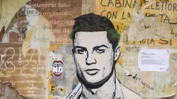 Sebuah mural dengan gambar bintang Juventus, Cristiano Ronaldo, yang terdapat di Milan, Senin (19/3). Mural berjudul Cristiano's Secret ini karya seniman Italia, TvBoy. (AFP/Miguel Medina)