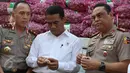 Menteri Pertanian Amran Sulaiman mengecek kualitas bawang putih yang diimpor dari Tiongkok saat operasi pasar di Pasar Induk Kramat Jati, Rabu (17/5). Sebanyak 9.000 ton bawang putih dijual dengan harga Rp 25 ribu per kg. (Liputan6.com/Immanuel Antonius)