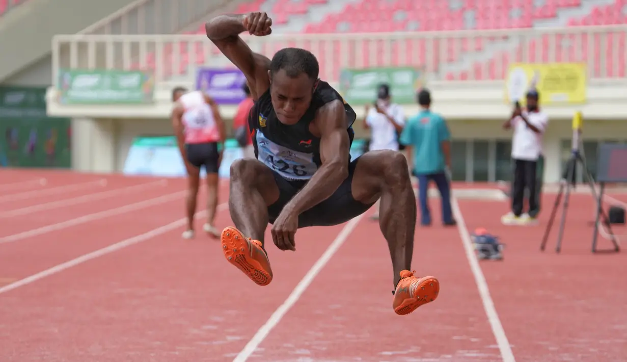 Atlet andalan Papua, Jimmy Y. Suebu melakukan lompatan pada cabang olahraga atletik nomor final lompat jauh putra klasifikasi T11 di arena lompat jauh Stadion Lukas Enembe, Sabtu 6/11/2021). Berdasarkan data Minggu (7/11), total ada 20 medali berhasil dikumpulkan Papua. PB. PEPARNAS XVI/Thino Yepese
