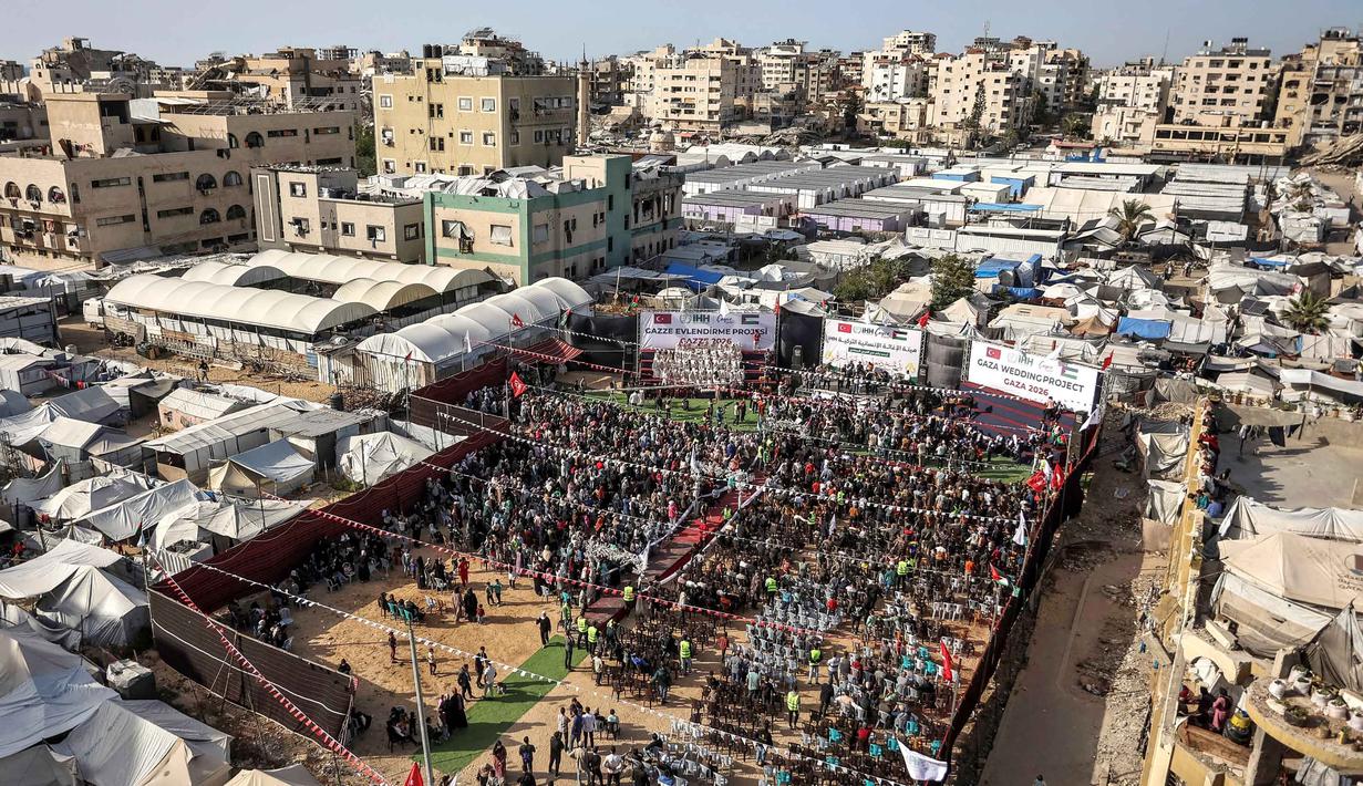 Orang-orang berkumpul selama perayaan pernikahan massal untuk para pengantin Palestina yang diselenggarakan oleh Yayasan Bantuan Kemanusiaan Turki (IHH) di Kota Gaza pada 11 Mei 2026. (Omar AL-QATTAA/AFP)